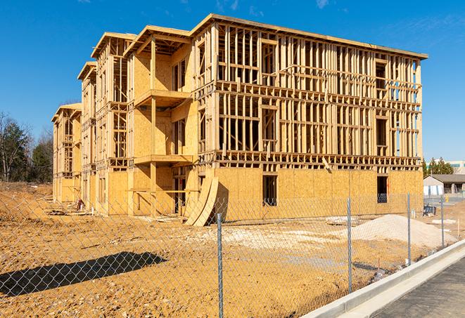 a snapshot of temporary chain link fences protecting a large construction project from unauthorized access in Cashion